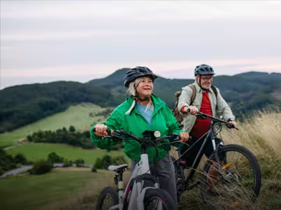 a couple riding bikes in the foothills