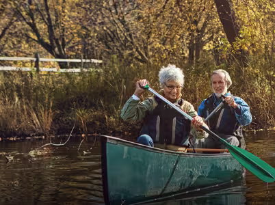 A couple kayaking down a river